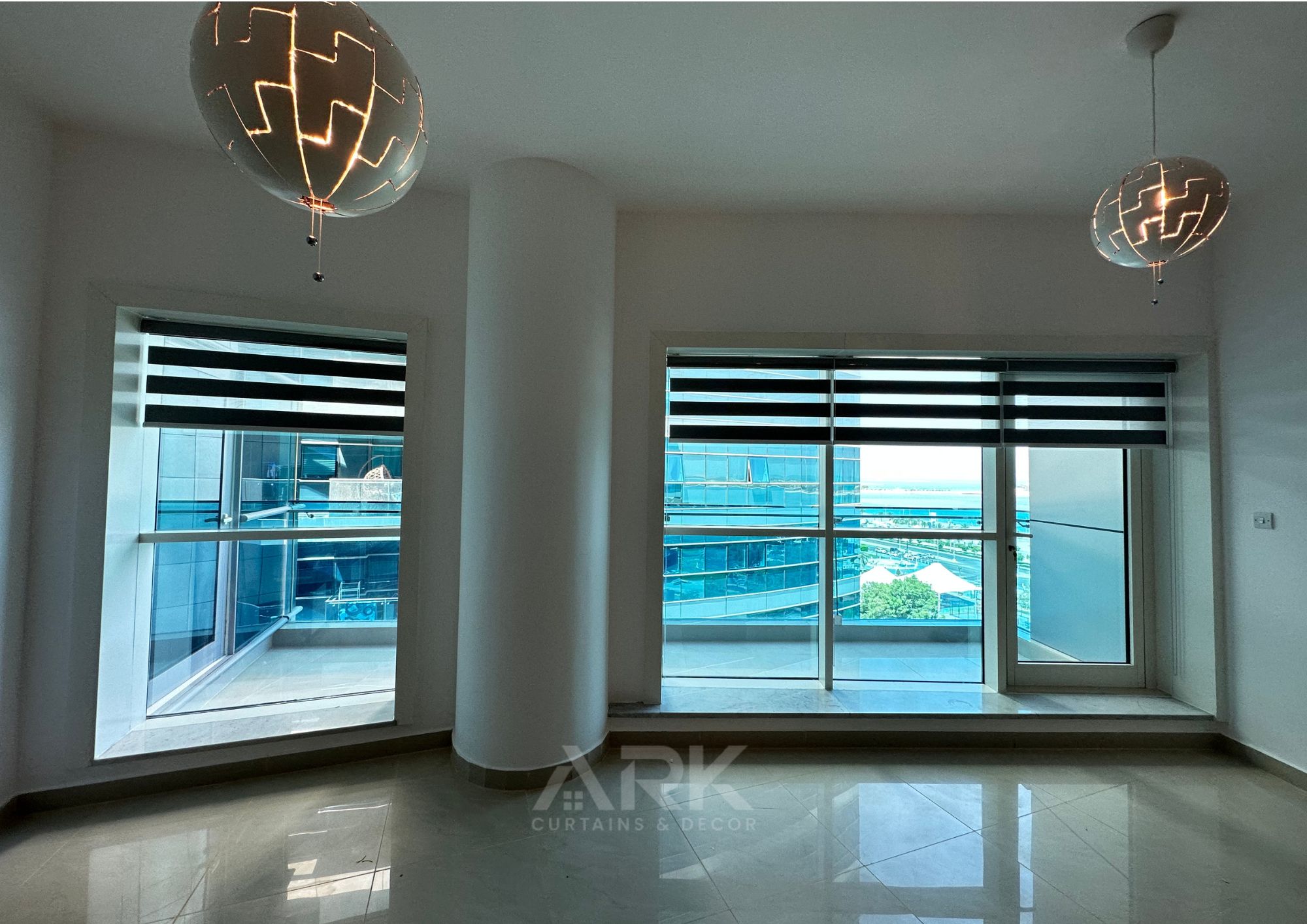 Zebra blinds partly open with a city view