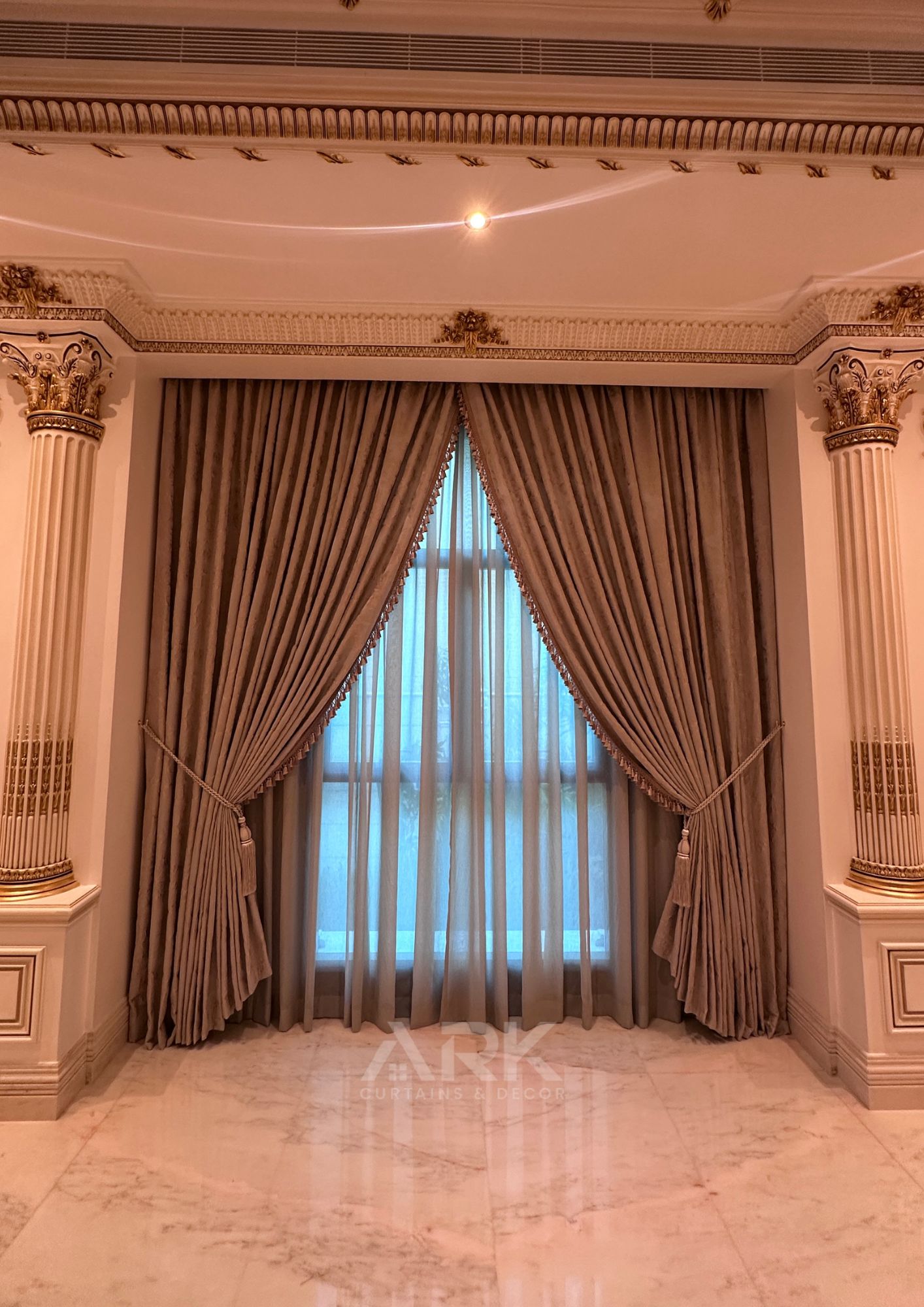 Tall window with tied-back pleated curtains and sheer centre panel