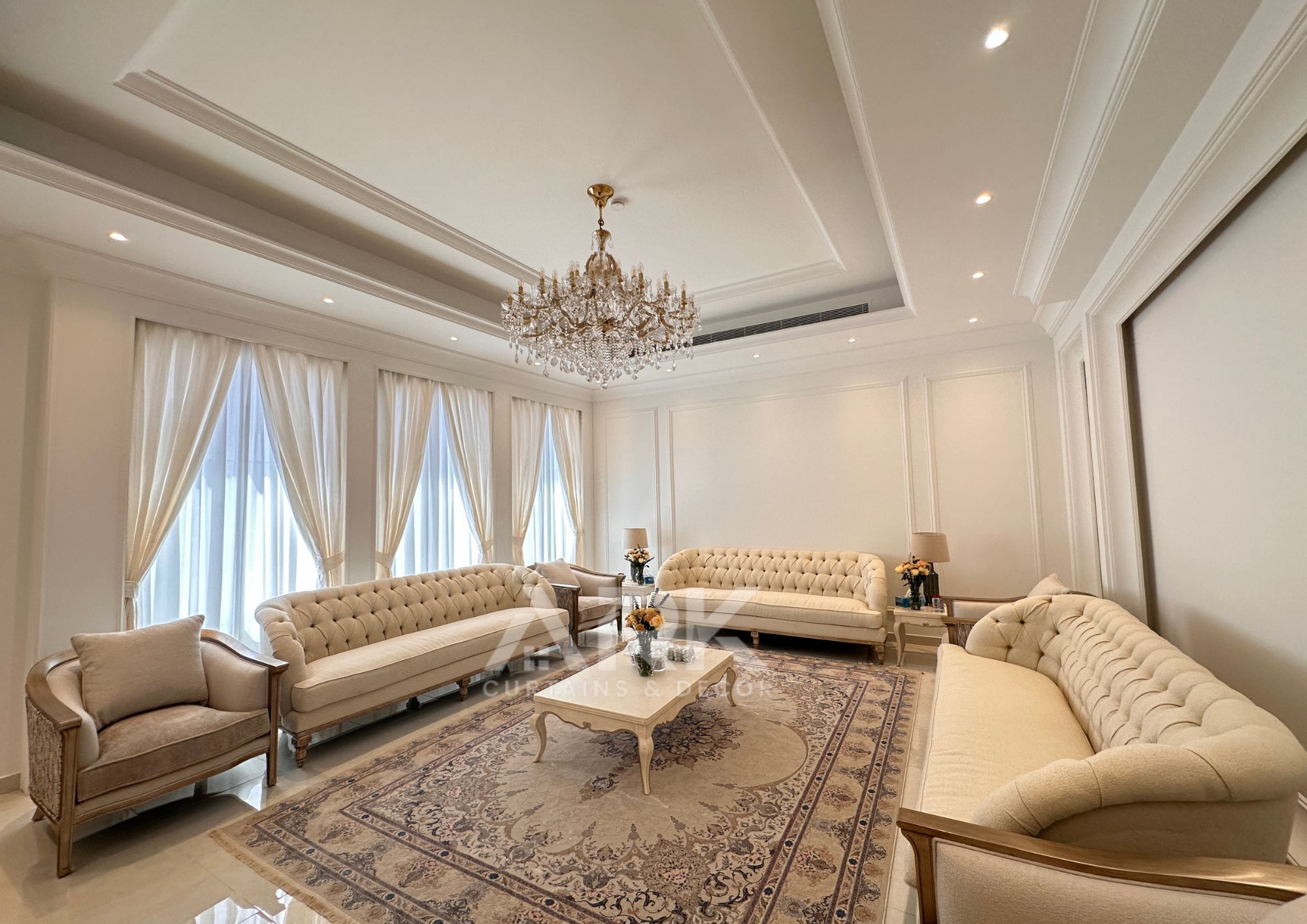Majlis with ornate chandeliers and flowing curtains