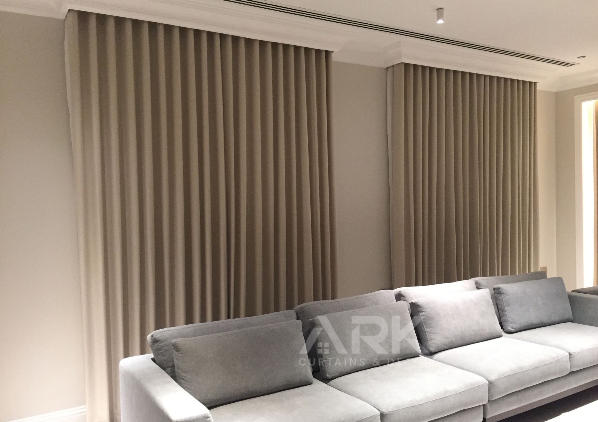 Layered sheer and blackout curtains in a modern room