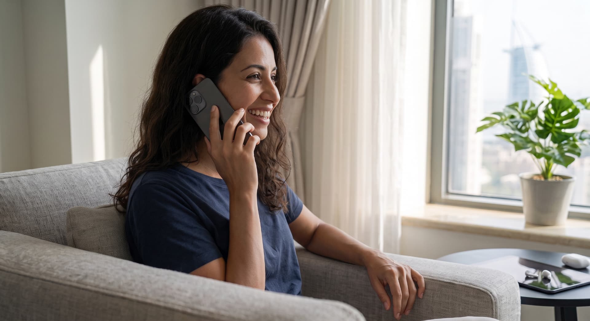 Ark Curtains & Decor customer speaking with support on the phone at home in Dubai