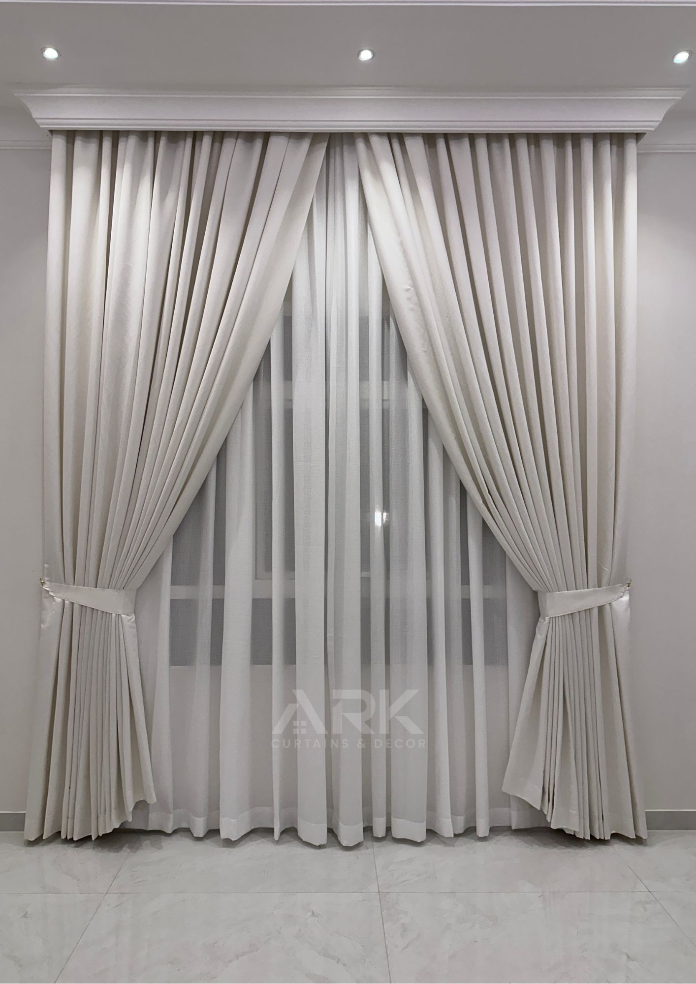 Tied-back pleated curtains with a sheer layer