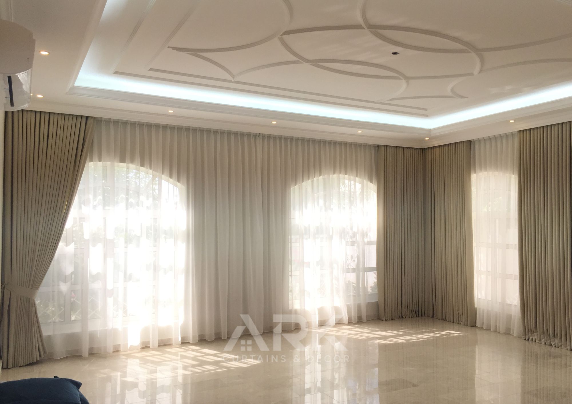 Elegant majlis with L-shaped sofa and curtains