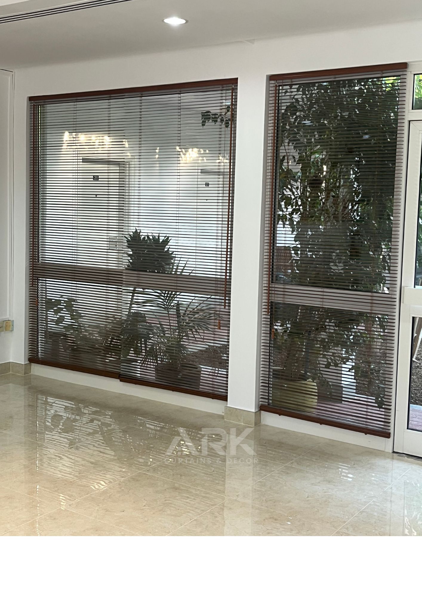 Dark wooden venetian blinds in a bright interior